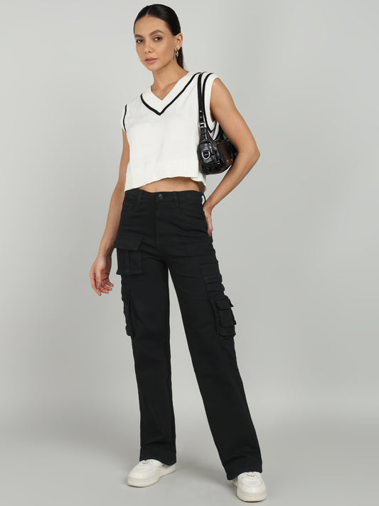 Trendy black cargo denim jeans from OMG Jeans, featuring a high-waist design with multiple utility pockets, paired with a stylish cropped sweater vest and sneakers for a chic streetwear look.