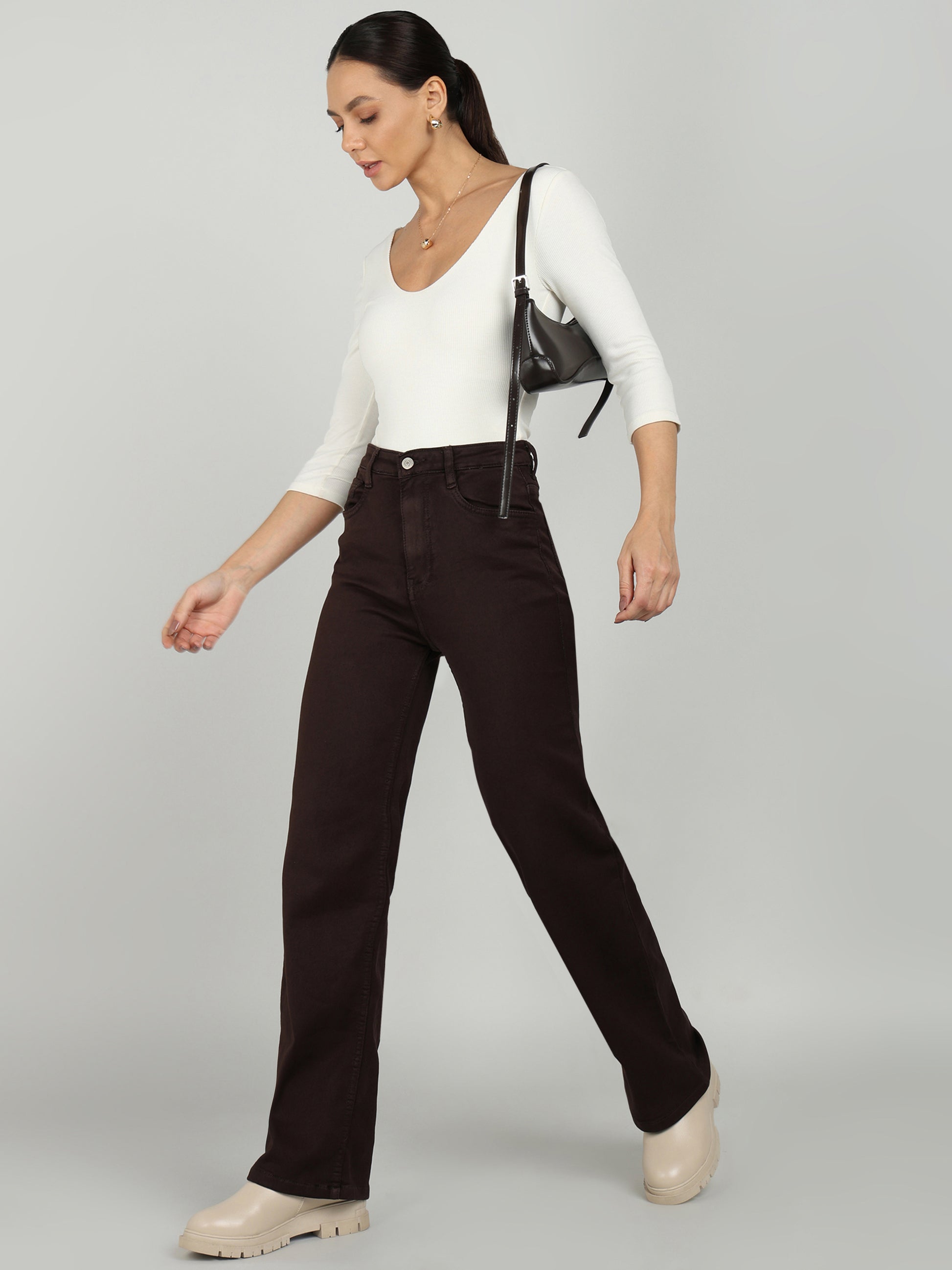  Stylish brown straight-fit denim jeans from OMG Jeans, paired with a white top and beige platform shoes for a sleek and modern casual look.